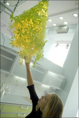 Менеджер-дизайнер магазина ”100% интерьер” Мария Лебедева показывает необычную люстру