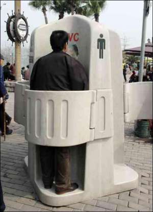 Мужчина пользуется новым туалетом на улице Иностранцев в городе Чунцин, Китай