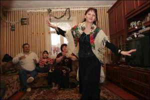 Жанна Разуваева танцует шадрицу в жилище семьи Григориченков. Слева Сергей Григориченко — председатель Волынской цыганской  организации ”Терне Рома”