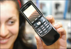 Директор столичного магазину ”Мобілочка” Лілія Бровар показує новинку від ”Нокії” — модель 8800. Такий телефон коштує 6700 гривень. У ньому компанія вперше поставила роз’єм мікро-USB