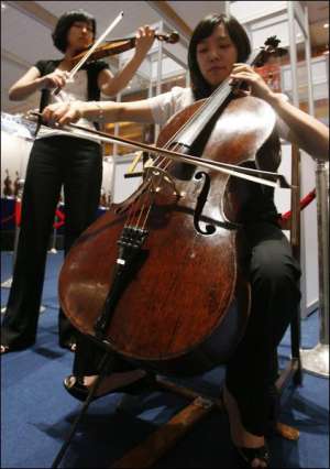 Виолончелистка Ким Хияи (впереди) и скрипачка Пак Яйон играют на старинных итальянских инструментах на международной музыкальной ярмарке ”Мюзик Кориа 2007”. Виолончель мастера Гаспаро де Сало, изготовленную в XVI веке, продали более чем за миллион долларо