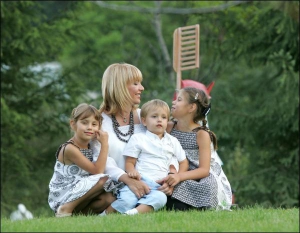 Катерина Ющенко з дітьми Христиною, Тарасом і Софією на подвір’ї свого будинку в Нових Безрадичах під Києвом. 28 серпня 2006 року
