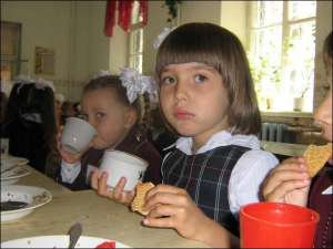 У Полтавській школі №3 снідає першокласниця Аня Рясна (в центрі). Повний сніданок коштує 3,5 гривні. З них 2 гривні платить місцева влада