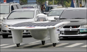 Один из студентов, разработавших первую филиппинскую машину на солнечных батареях, едет по центру столицы Манилы