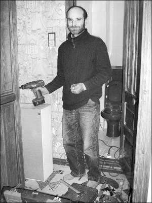 Руслан Сиченко у квартирі Наконечних вішає шафу в туалеті. Майстра викликали, бо у плитці потрібно було обережно просвердлити отвори