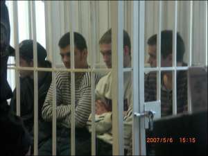 Справа наліво: Єгор Барков, Микита Поліщук, Дмитро Нуца та Ілля Головський слухають вирок суду 5 травня. Вони отримали по 13 років в’язниці
