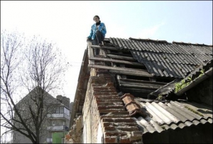 Оксана Турейчук сидит на крыше своего дома в райцентре Коломыя Ивано-Франковской области. Иногда женщину сменяют мать и тетя