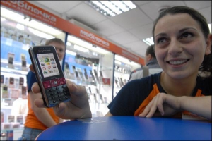 Експерт із продажу Тамара Пашаєва, 19 років, показує новий ”Соні Ерікссон К660”. У ”Мобілочці” сподіваються, що телефон купуватиме молодь