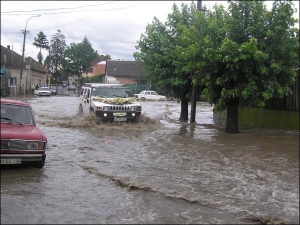 Весільний автомобіль проїжджає затоплене перехрестя вулиць Тельмана, Української та Дворжика в Ужгороді. Вода тут стояла кілька днів після дощів