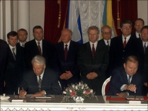 Президенты России и Украины — Борис Ельцин (слева) и Леонид Кучма подписывают Договор о дружбе, сотрудничестве и партнерстве 31 мая 1997 года. Позади справа налево стоят: глава Администрации президента Украины Евгений Кушнарев, премьер Павел Лазаренко, ди