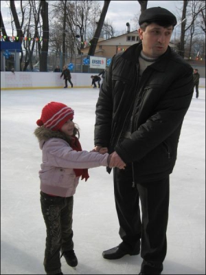 5-летняя Алина Януш в первый раз стала на коньки на новой ледовой площадке в Хмельницком. Чтобы не упасть, девочка держится за руку отца Станислава