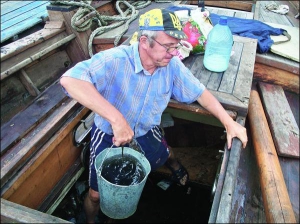 Львовянин Мирон Колодко вычерпывает воду из трюма казацкой чайки ”Спас” в херсонском порту