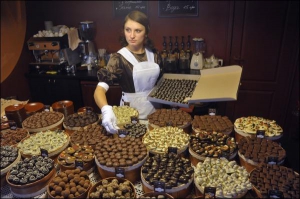 Продавець ”Львівської майстерні шоколаду” Олена Амбрузевич викладає цукерки ”Ванільна атракція” на стійку магазину-кав’ярні, що на вулиці Сербській, 3. До 35 видів солодощів вручну роблять четверо шоколатьє