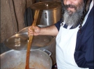 Главный повар на кухне для малоимущих евреев Ан Шин открывает крышку 200-литровой кастрюли. Там варятся помидоры и лук. Таких кастрюль более двух десятков