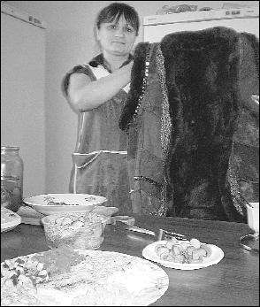 Світлана Карп у ресторані ”Лемківський хутір” у селі Великі Ходачки на Тернопільщині показує традиційний лемківський одяг. На столі – салат ”Веселка” і мариновані грибочки