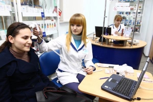 Консультант ”Аптеки гормональних препаратів” Марина Горобець перевіряє сканером волосся киянки Марії. Рекомендує мити голову лопухом