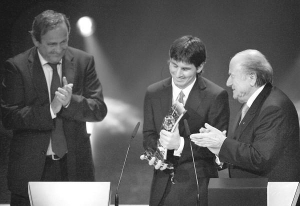 Лионель Месси получает приз лучшего футболиста мира-2009 из рук президента ФИІФА Зеппа Блаттера. Слева стоит руководитель Европейской футбольной федерации Мишель Платини