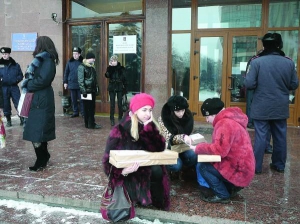 Глава комиссии Оксана Барвинская (слева) сидит с бюллетенями у входа в территориальную избирательную комиссиюи в Ивано-Франковске