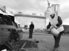 Работники коммунальной службы посыпают песком пятна крови на асфальте, а специальной смесью — разлитый бензин