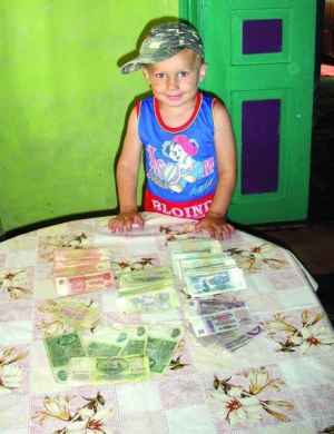 Ярослав Гусак стоїть біля столу, на якому викладені радянські гроші: 2860 карбованців купюрами по 1, 3, 5, 10, 25 та 50
