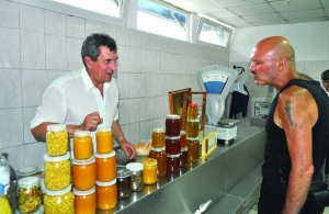 Пчеловод Николай Тименко торгует медом на Лукьяновском рынке столицы. Литровую банку продает за 100 гривен. За полчаса товаром заинтересовался один покупатель