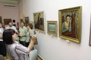 Відвідувачка Кіровоградського художнього музею фотографує портрет дружини Володимира Винниченка Розалії. У квітні 11 полотен письменника повернули із США