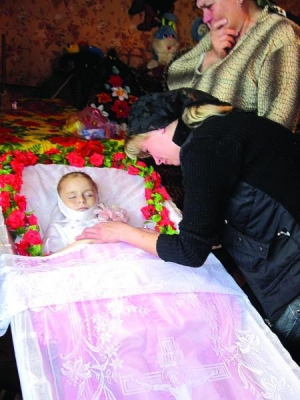 Леся Сивенок из города Мена Черниговской области склонилась над телом дочки Карины. Но погибла от кровоизлияния в мозг, образовавшегося после падения