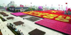 Участники парада в честь 65-летия Трудовой партии Северной Кореи движутся через площадь Ким Ир Сена в столице Пхеньяне. Во время праздника демонстрировали также танки и ракеты