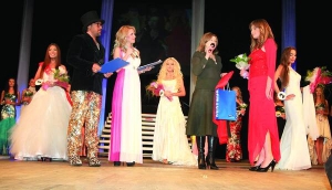Вікторії Обрізан (у червоній сукні) із Семенівщини вручають подарунки як переможниці в номінації ”Королева по-українськи” конкурсу краси ”Королева Полтавщини-2010”