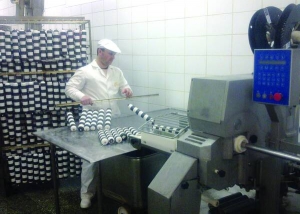 Працівник ковбасного цеху Володимир Качинський знімає готову ковбасу ”Патрульну”. Її часто купують як сувенір