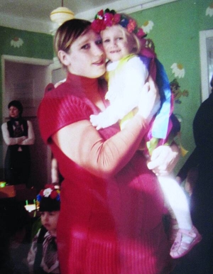 Оксана Зінченко тримає доньку Анастасію в дитячому садку під час ранку до свята 8 Березня. Жінка на восьмому місяці вагітності. Цей знімок зробили за 40 днів до смерті Оксани