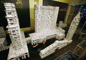 Браян Берг позує з картковою моделлю готелю ”Венеціан Макао” в Макао, Китай. Будівля з карт 10,5 метра завдовжки, 3 метри у висоту. Важить 272 кілограми. Щоб протяги не руйнували будівлю, Браян працював у закритій скляній кімнаті