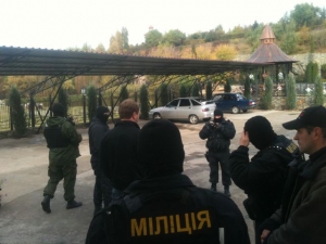 Евгений Суслов в окружении правоохранителей в масках