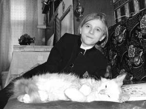 Житомирянин Ісус Христос Радзюк грається з котом Рижиком на дивані у своїй кімнаті. До школи хлопець не ходить через довге волосся