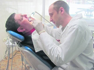 Лікар Олександр Задорожній, 34 роки, з Черкаської стоматполіклініки ставить пломбу черкащанину Дмитру Пилипенку. Працює на новій стоматустановці, яку купили для закладу минулого року