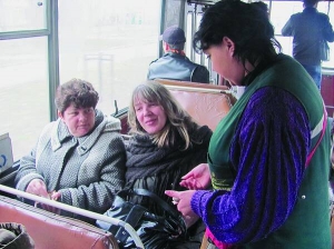 Кондуктор у черкаському тролейбусі №7  продає квитки пасажиркам. Скаржиться, що на підприємстві постійно затримують зарплату