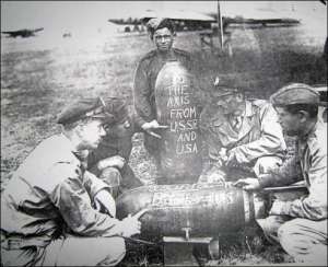Американський пілот (другий справа) та радянські військові, що брали участь в операції ”Френтик”. На одній із бомб написано: ”Німеччині та її союзникам від СРСР і США”. Полтавський аеродром, літо 1944-го 