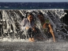 Неудачно спрятались - волна накрыла моодую пару под парапетом набережной. Гавана, 27 ноября 2013.