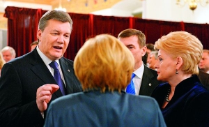 Президента України Віктора Янукович розмовляє з канцлером Німеччини Ангелою Меркель, президентом Литви Далею Грібаускайте і прем’єр-міністром Естонії Андрусом Ансипом на вечері під час саміту у Вільнюсі.  28 листопада 2013 року