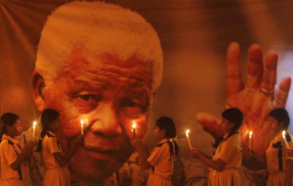 Утрата недели: 5 декабря на 95 году жизни скончался Нельсон Ролилахла Мандела - борец с апартеидом, за что 27 лет осидел  в тюрьме, первый чернокожий президент Южно-Африканской республики (1994-1998 гг.). На снимке школьники индийского города Ченнаи во время поминальной молитвы, 6 декабря 2013. 
