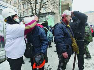 Волонтери-медики перев’язують поранених під час сутичок у центрі Києва. За ніч по допомогу звертаються понад два десятки людей. У ніч на 23 січня щонайменше двоє активістів отримали ушкодження очей