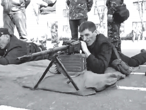 Чоловік учиться користуватися кулеметом під час навчальних зборів, які проходили на подвір’ї Полтавського обласного військового комісаріату