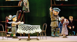 Поліцай забирає дівчину Іринку з дому в ляльковій виставі про Другу світову війну ”Суворий іспит”. У Вінницькому ляльковому театрі її покажуть у жовтні