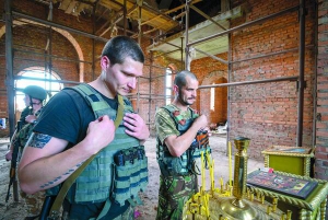 Українські солдати моляться в недобудованій церкві поблизу селища Піски, 6 липня