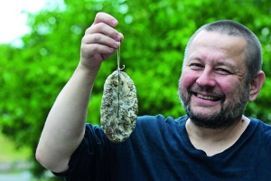 Білорус Андрій Азаров тримає кільце сиров’яленої ковбаси власного виробництва. За місяць виготовляє 100 кілограмів. ­Вартість одного — 400–450 гривень