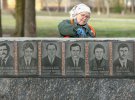 Комунальниця ремонтує стіну з меморіальними табличками ліквідаторів аварії на Чорнобильській атомній електростанції 26 квітня 1986 року