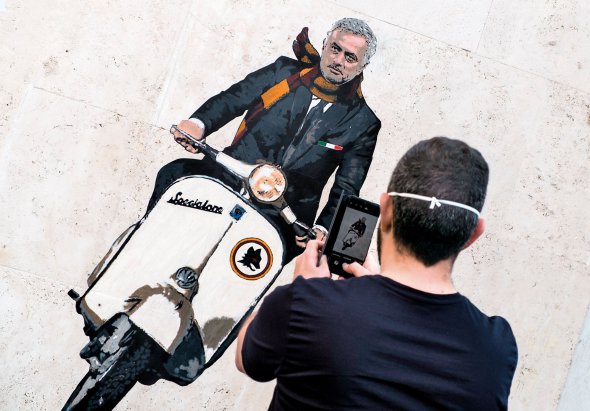 Чоловік фотографує фреску художника Гаррі Греба в Римі, на якій зображений Жозе Моуріньйо – новий головний тренер італійського футбольного клубу ”Рома”