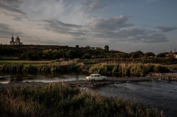 Авто выезжает из оккупированной Россией Херсонской области по импровизированному мосту 