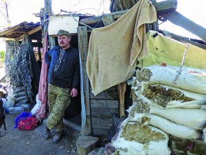 Військовий Юрій ”Маклер” стоїть біля одного з бліндажів взводно-опорного пункту