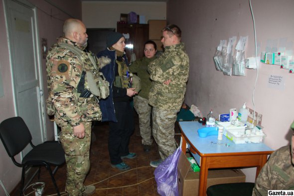 Медики ПДМШ чергують у стабпункті, в короткі хвилини між надходженням поранених обговорюють план роботи - хтось зараз має їхати на довге плече евакуації, інша бригада залишається чергувати